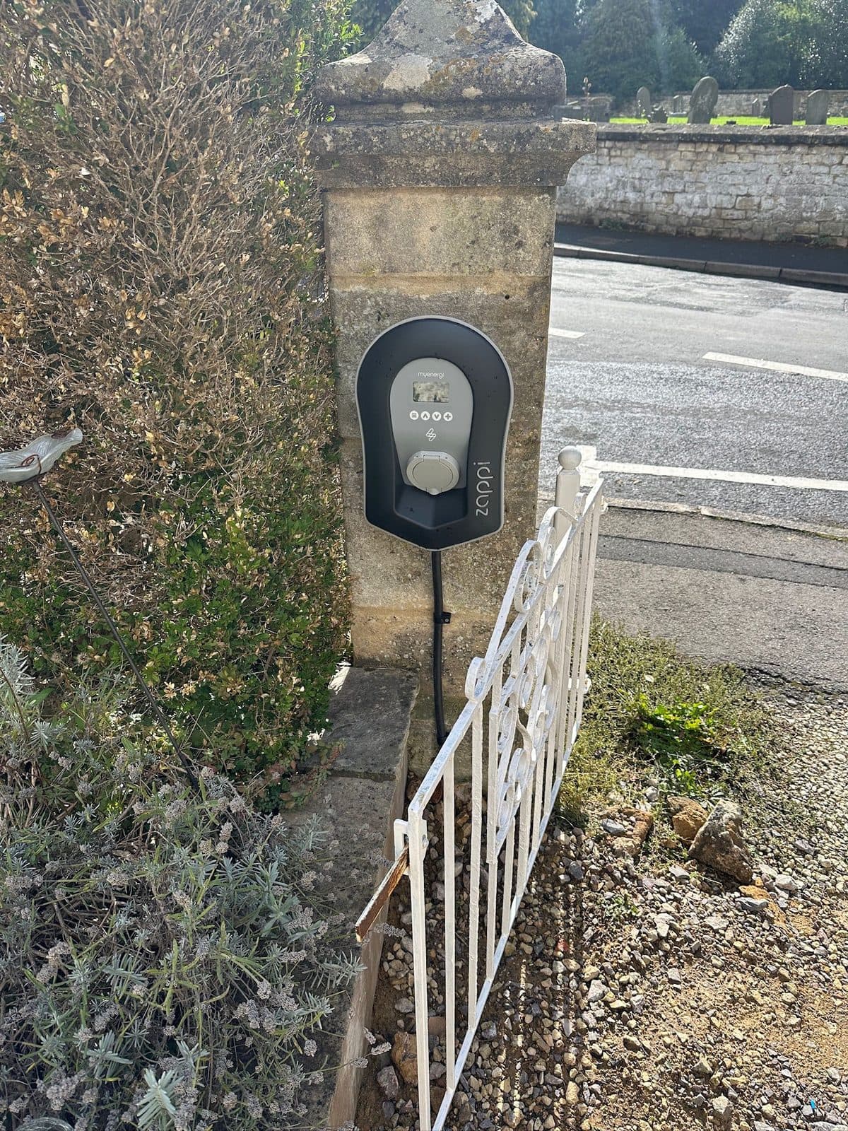 myenergi Zappi EV charger mounted on a stone gatepost