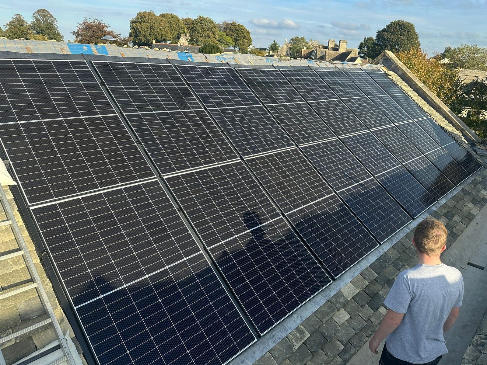Roof-mounted solar PV array installed across a Cotswold stone roof